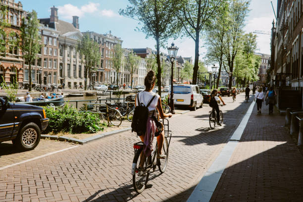 cycling commute in amsterdam, the netherlands - travel stock pictures, royalty-free photos & images