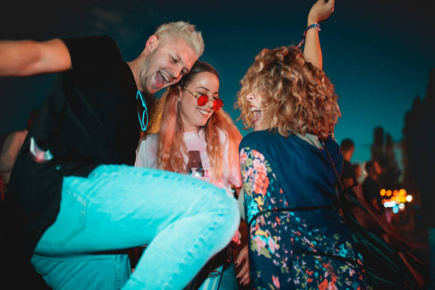 dancing at outdoor music festival - concert stock pictures, royalty-free photos & images