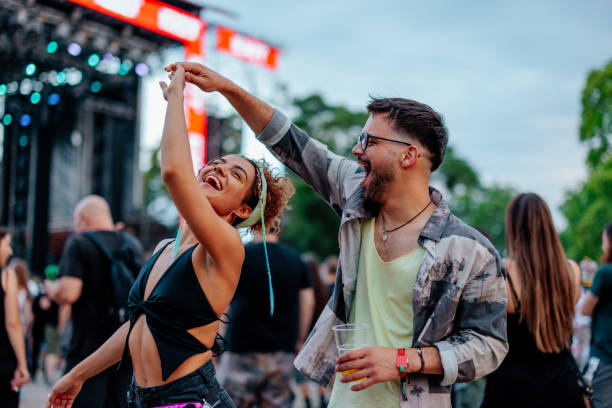 dancing couple at concert - concert stock pictures, royalty-free photos & images