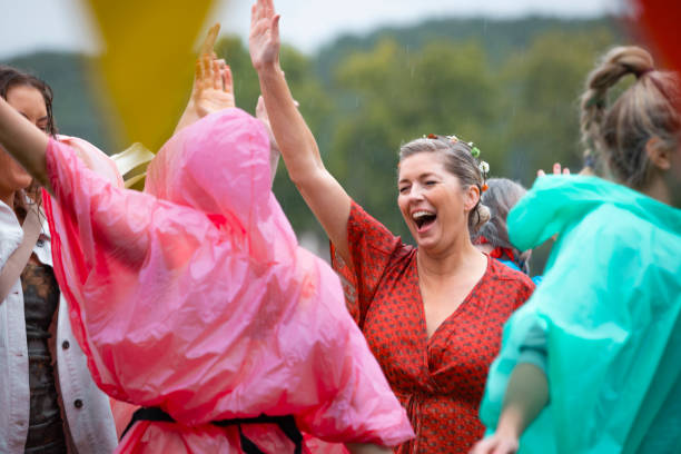 dancing in the rain - concert stock pictures, royalty-free photos & images