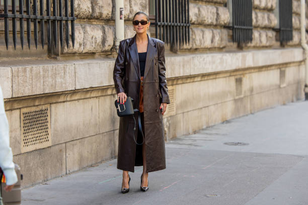 Darja Barannik wears brown leather short, brown shorts, black top, black bag outside Hermes during the Womenswear Spring/Summer 2024 as part of Paris...