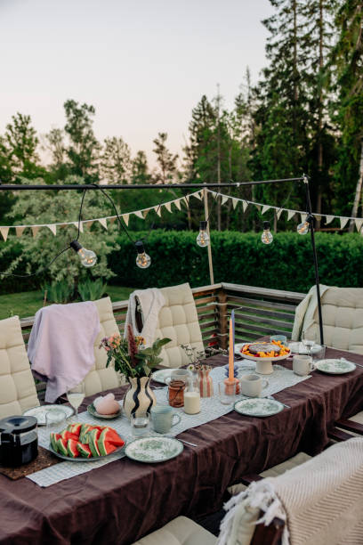 decorated patio with food and drinks arranged on table - garden decoration stock pictures, royalty-free photos & images