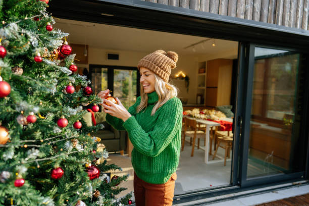 decorating my christmas tree - garden decoration stock pictures, royalty-free photos & images