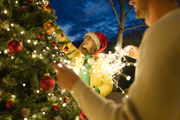 decorating our christmas tree - garden decoration stock pictures, royalty-free photos & images