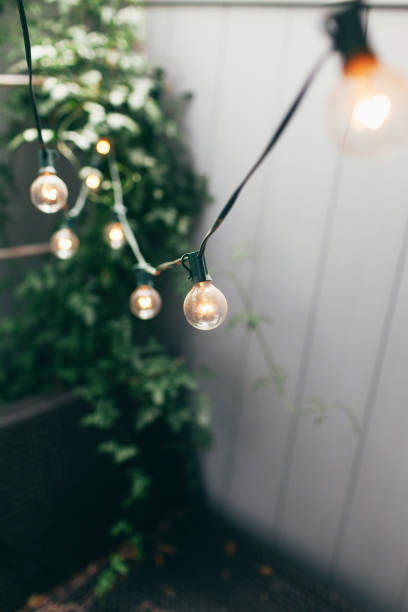 decorative party lights in backyard - garden decoration stock pictures, royalty-free photos & images