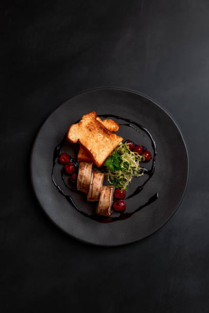 deer minced meat terrine dish duck breast with balsamic cherries in michelin star gourmet restaurant on dark background - food stock pictures, royalty-free photos & images