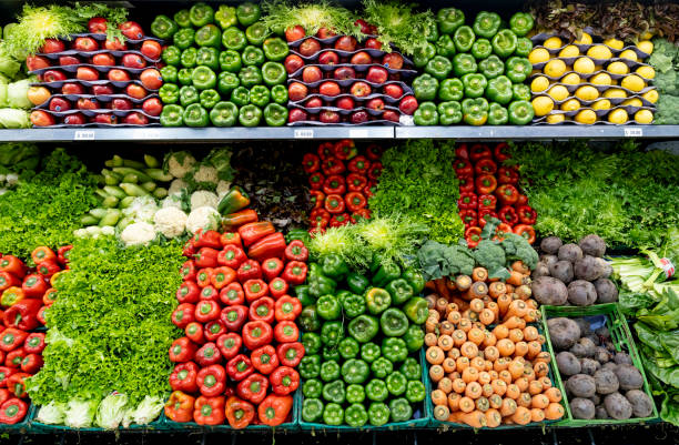 delicious fresh vegetables and fruits at the refrigerated section of a supermarket - food stock pictures, royalty-free photos & images