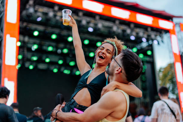 delighted couple at music festival. - concert stock pictures, royalty-free photos & images