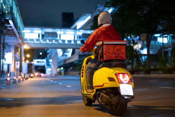 delivery man driving a scooter - food stock pictures, royalty-free photos & images