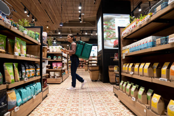 delivery person selecting products at the supermarket - junk food stock pictures, royalty-free photos & images