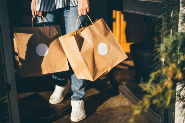 delivery woman picking up take away food order. - junk food stock pictures, royalty-free photos & images