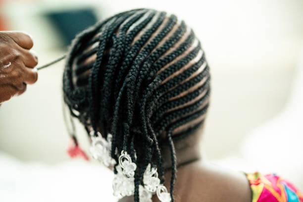 detailed of daughter's hair by her mother - hairstyle stock pictures, royalty-free photos & images