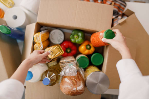 details of volunteer with box of food for poor - food stock pictures, royalty-free photos & images