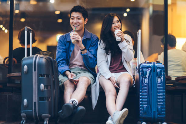 deux touristes asiatiques avec les valises, passer du temps heureux au café - travel photos et images de collection