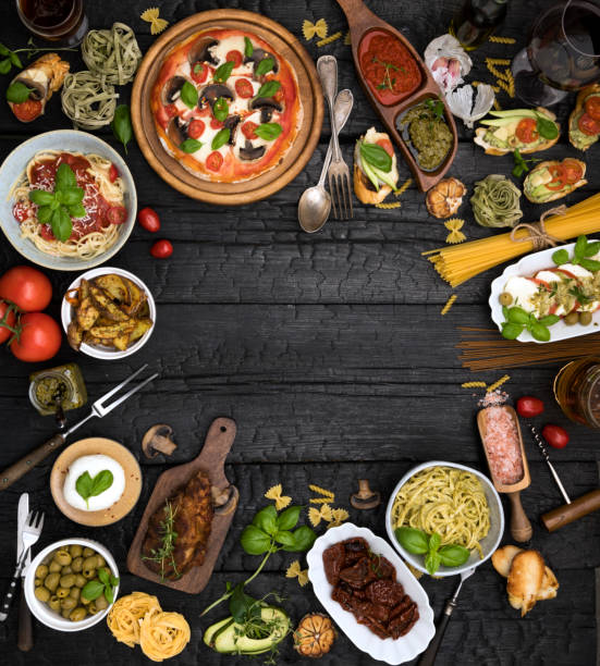 different food cooked on a dark wooden background - food stock pictures, royalty-free photos & images