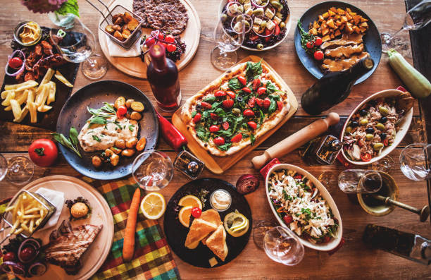 different food cooked on a wooden table - food stock pictures, royalty-free photos & images