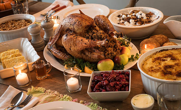 dining table filled with thanksgiving food - food photos et images de collection