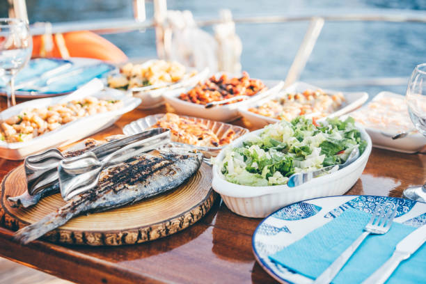 dinner on sailboat. - food stock pictures, royalty-free photos & images