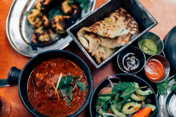 directly above shot of assorted authentic indian food in plates on table - junk food stock pictures, royalty-free photos & images