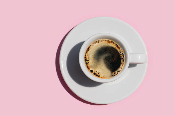 directly above shot of coffee on pink color background. - coffee stock pictures, royalty-free photos & images