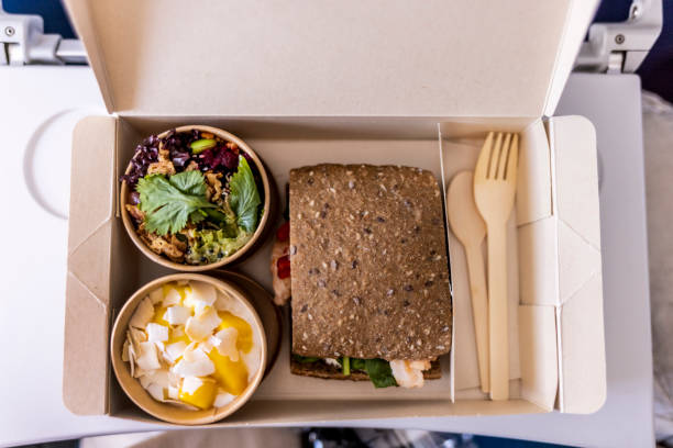 directly above shot of eating economy class lunch set on the plane - junk food stock pictures, royalty-free photos & images