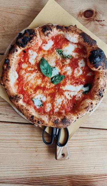 directly above shot of pizza on table - junk food stock pictures, royalty-free photos & images