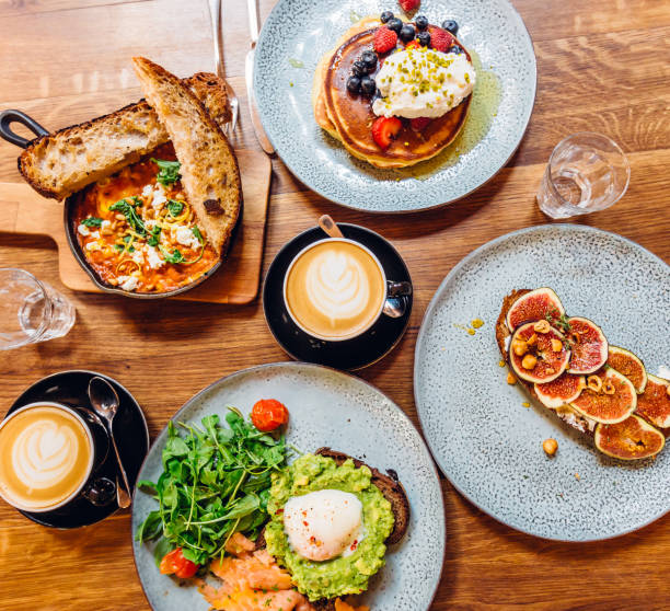 directly above view of breakfast with coffee on wooden table - food photos et images de collection