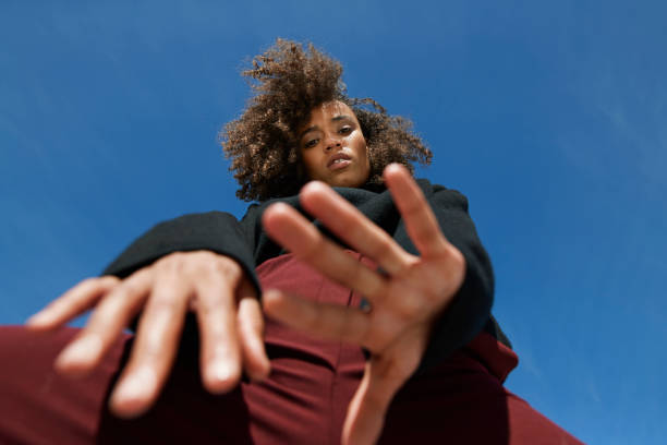 directly below portrait of woman against blue sky - fashion stock pictures, royalty-free photos & images