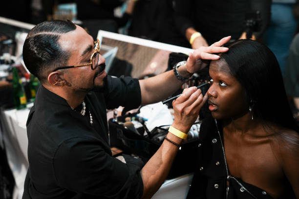 Director of Makeup for MAC Cosmetics, Romero Jennings, prepares a model backstage at the Kim Shui fashion show during 2025 New York Fashion Week on...