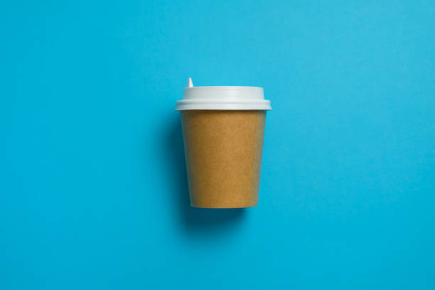 disposable paper cup with lid for coffee and tea on a bright pastel blue background. coffee break. the concept of environmental protection. copy space. - junk food stock pictures, royalty-free photos & images