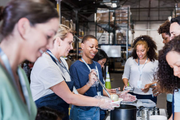 diverse group of volunteers working at the warehouse - food stock pictures, royalty-free photos & images
