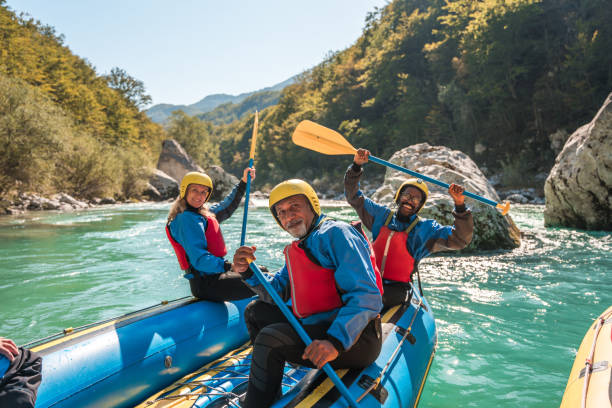 diverse mature group river rafting in natural setting - travel stock pictures, royalty-free photos & images
