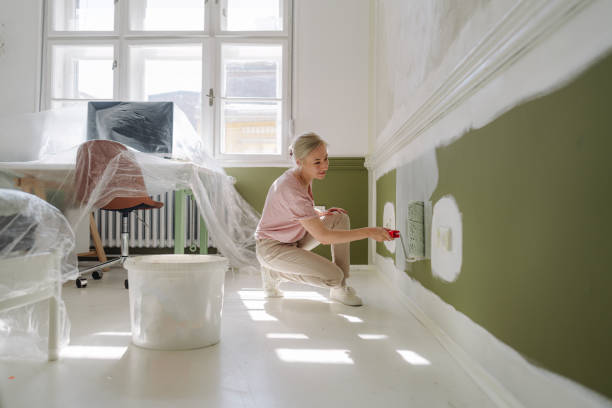 diy: a woman's painting her own apartment - home decoration stock pictures, royalty-free photos & images