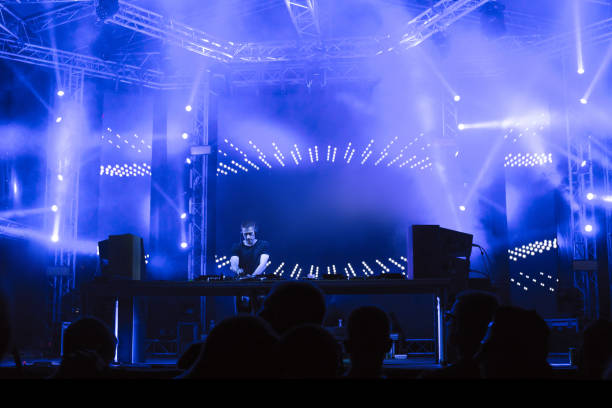 dj playing techno music on the stage - concert stock pictures, royalty-free photos & images