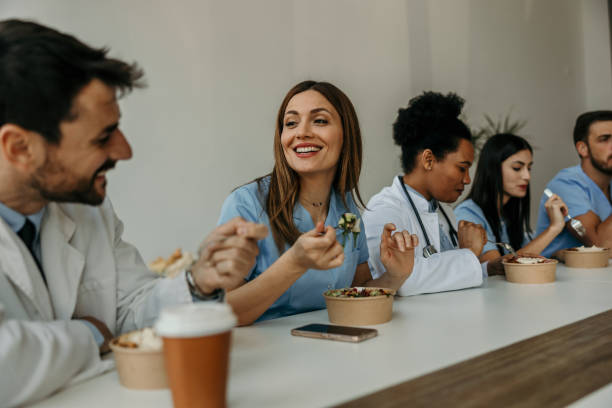 doctors and nurses bonding over lunch - junk food stock pictures, royalty-free photos & images