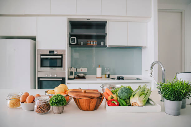 domestic kitchen with fruits and vegetables on kitchen counter - food stock pictures, royalty-free photos & images