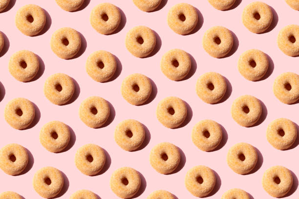 doughnuts on the pink background - junk food stock pictures, royalty-free photos & images