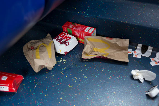 Dropped McDonalds packaging and food remains on the floor of a London bus, on 3rd October 2019, in south London, England.