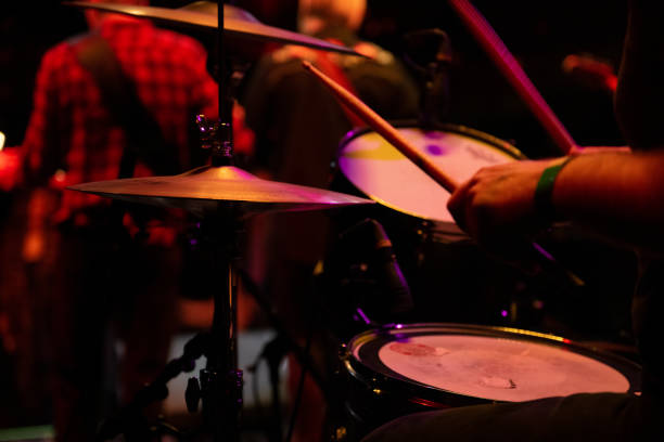drummer performing on stage with band - concert stock pictures, royalty-free photos & images