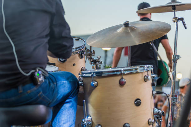 drummer sitting at his drum set before a live concert begins - concert stock pictures, royalty-free photos & images