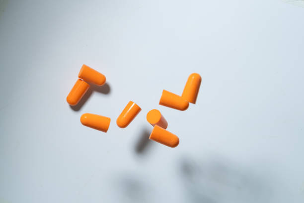 ear plug dancing in mid air with white background sync in high speed - concert stock pictures, royalty-free photos & images
