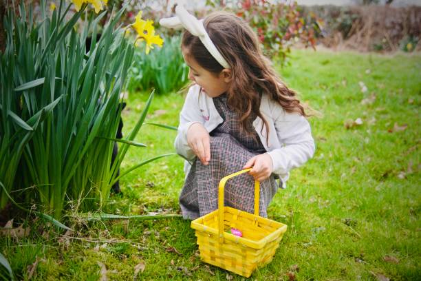 easter egg hunt with surprise - garden decoration stock pictures, royalty-free photos & images