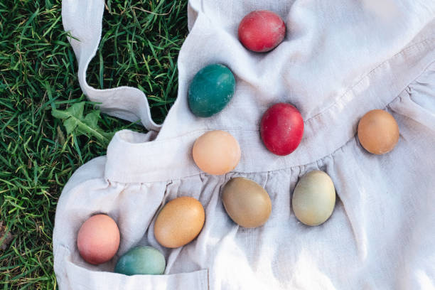 easter rustic colored eggs on linen cloth on the grass against blurred green background,belarus - garden decoration stock pictures, royalty-free photos & images