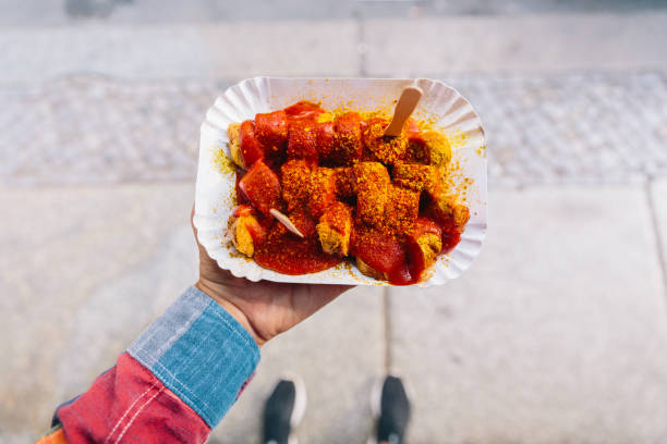 eating currywurst from personal perspective point of view - junk food stock pictures, royalty-free photos & images