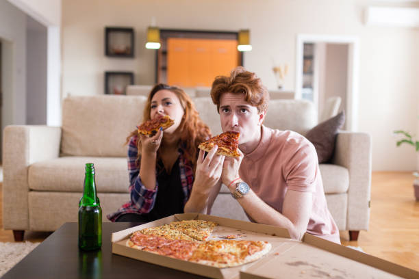 eating pizza - junk food stock pictures, royalty-free photos & images