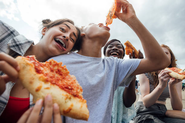 eating pizza and funny faces - junk food stock pictures, royalty-free photos & images