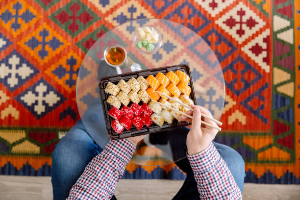 eating sushi at home, directly above personal perspective view - junk food stock pictures, royalty-free photos & images