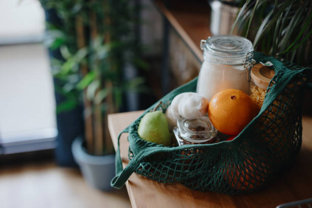 eco bag on kitchen counter with food in jars and fresh fruits. zero waste concept - food stock pictures, royalty-free photos & images