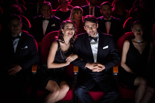 elegant couple watching opera performance - concert stock pictures, royalty-free photos & images