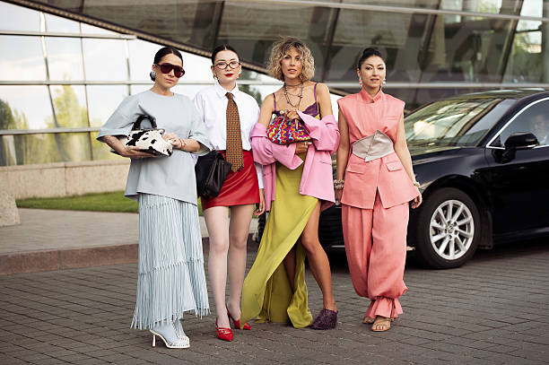 Elena Kolisnichenko wears light baby blue long maxi skirt with tassels, blue leather top, blue tights, white shoes, cow print bag and brown...